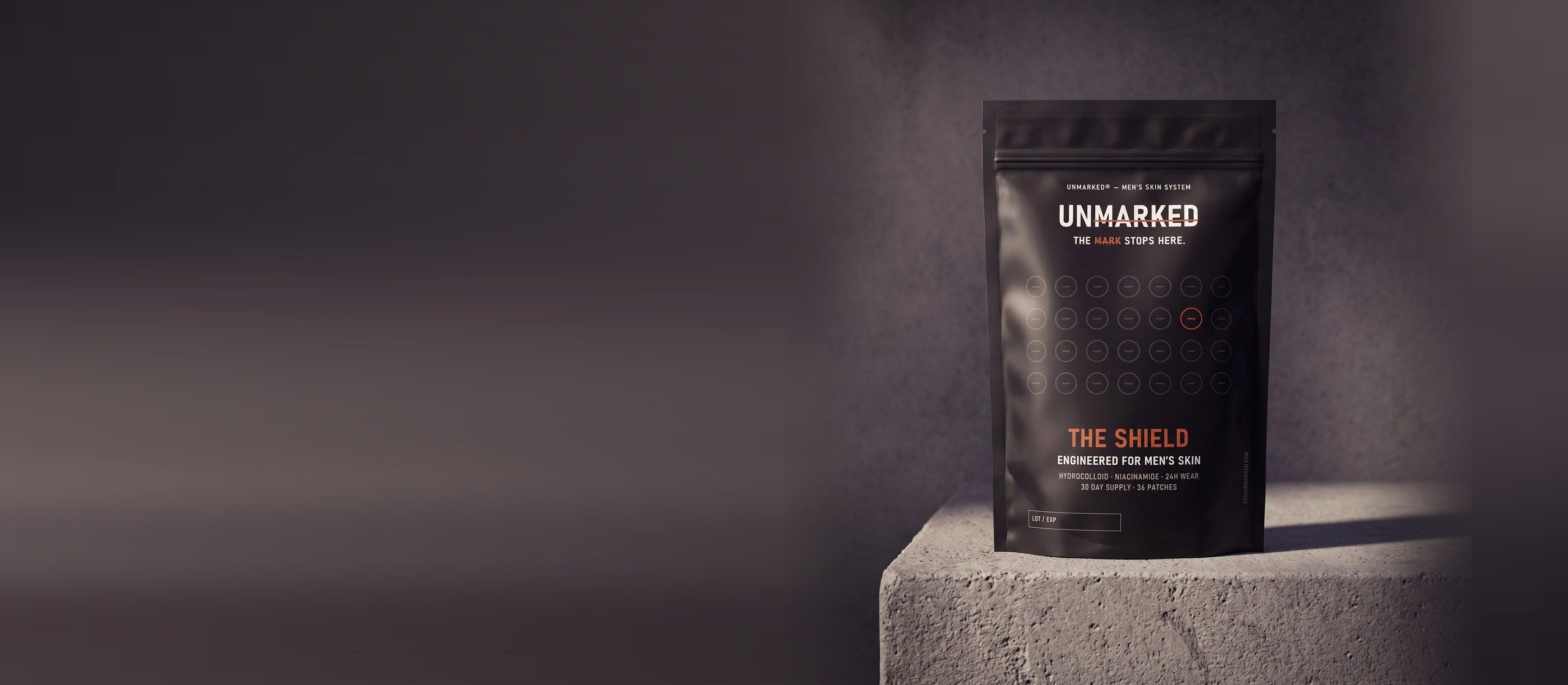 The Shield pouch on a concrete ledge in hard side light