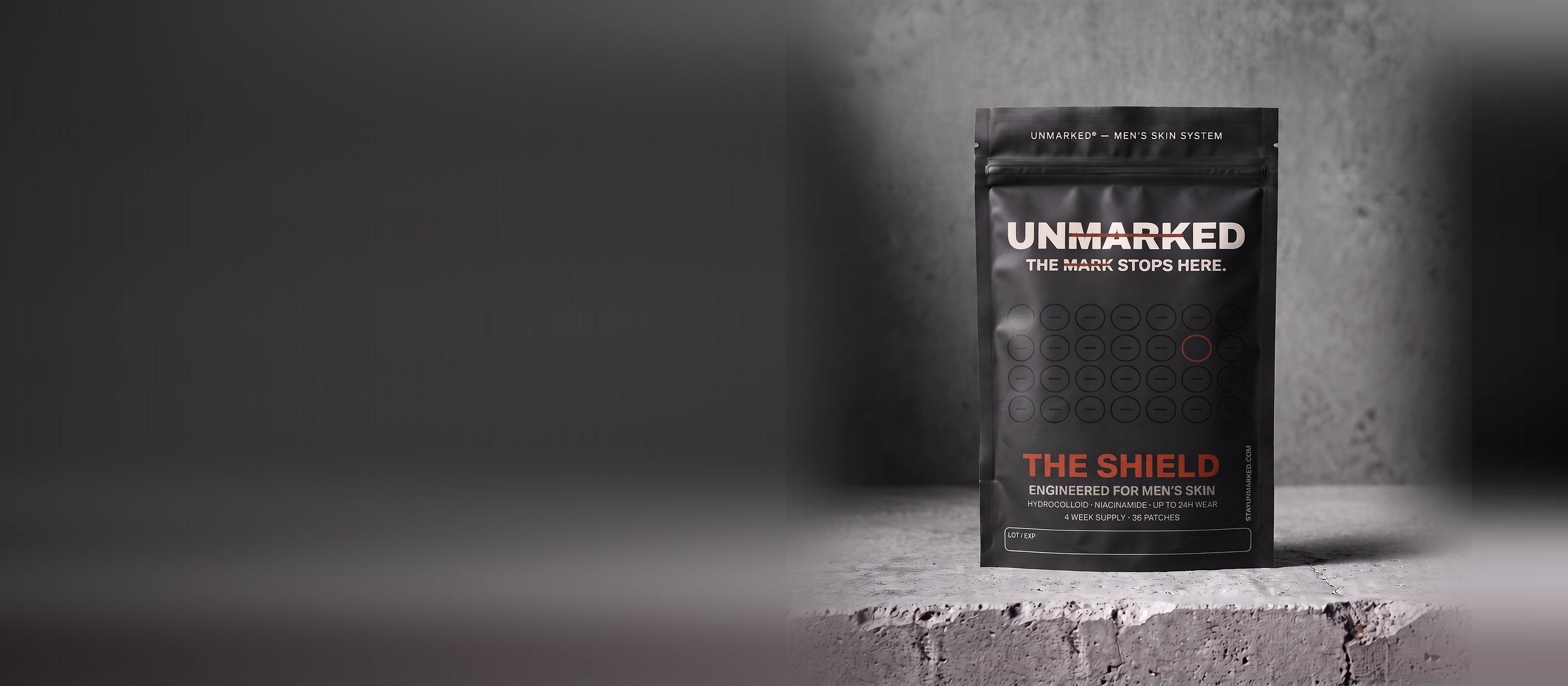 The Shield pouch on a concrete ledge in hard side light