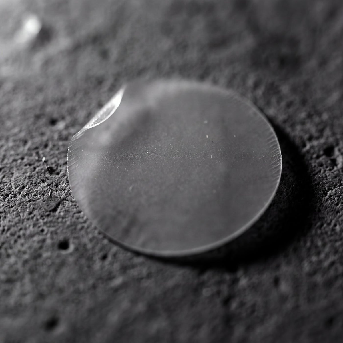 A single hydrocolloid patch, actual size, on concrete